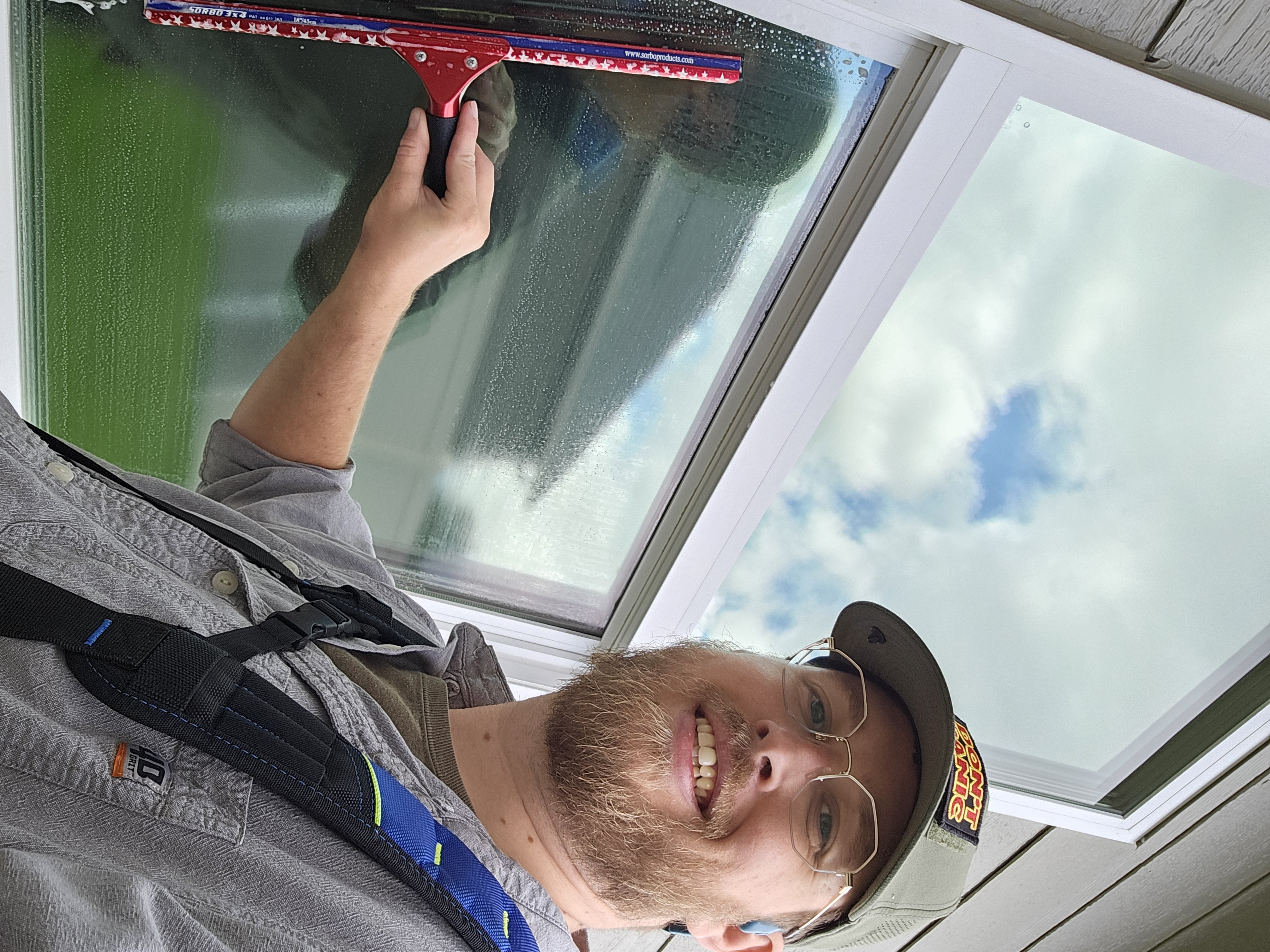 Clear Shine worker cleaning house exterior