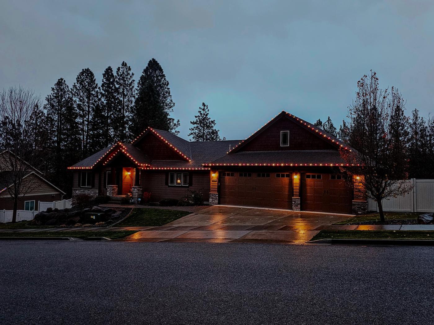 Christmas light installation on a home during the day