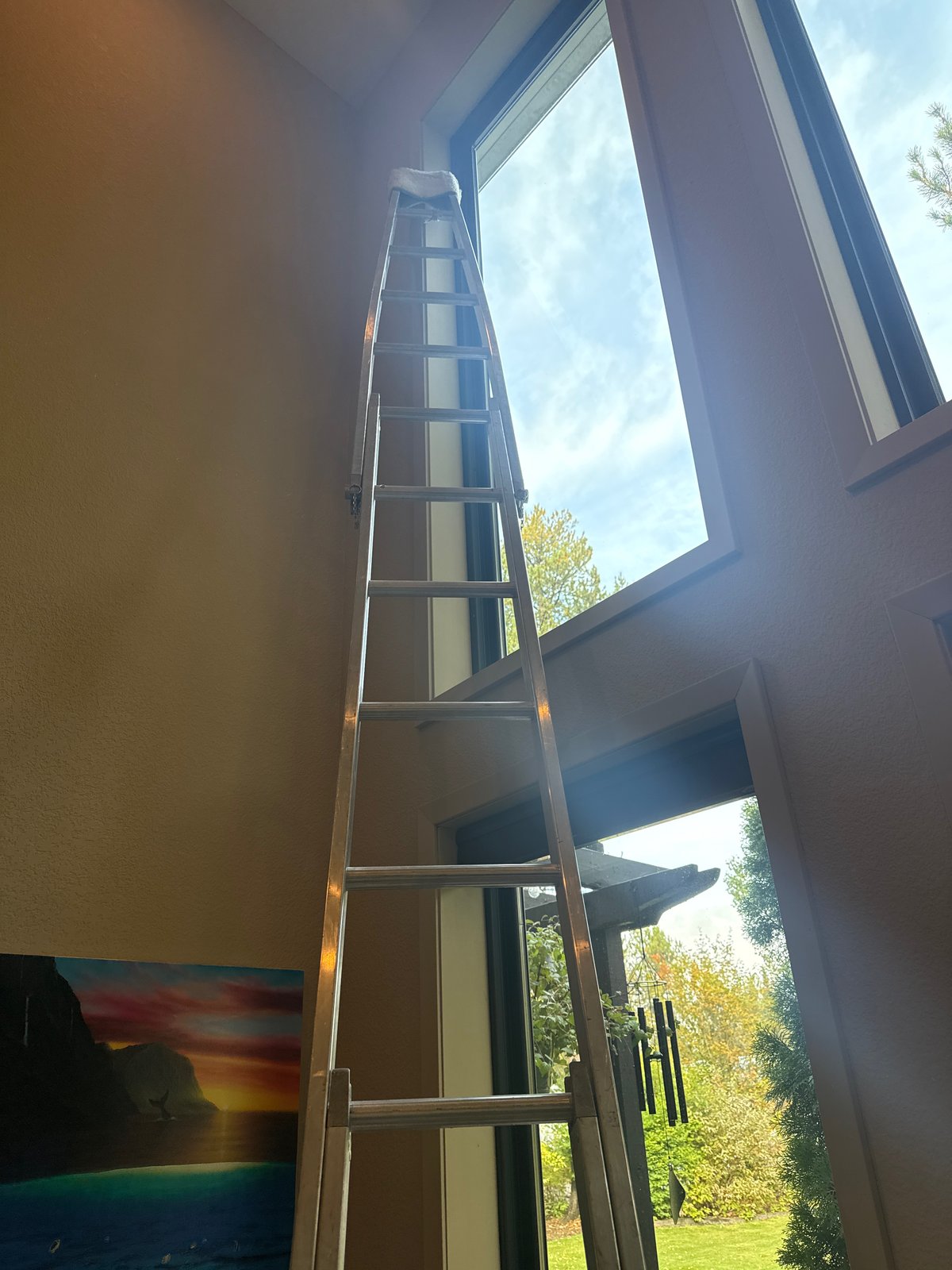 Extension ladder set for tall interior window cleaning